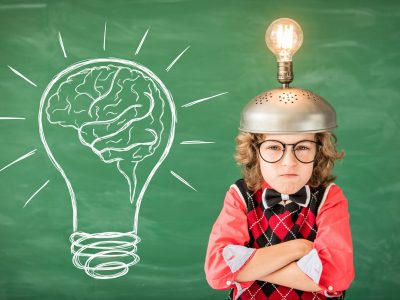 Portrait of child in classroom. Kid with toy virtual reality headset in class. Success, idea and creative concept. Back to school